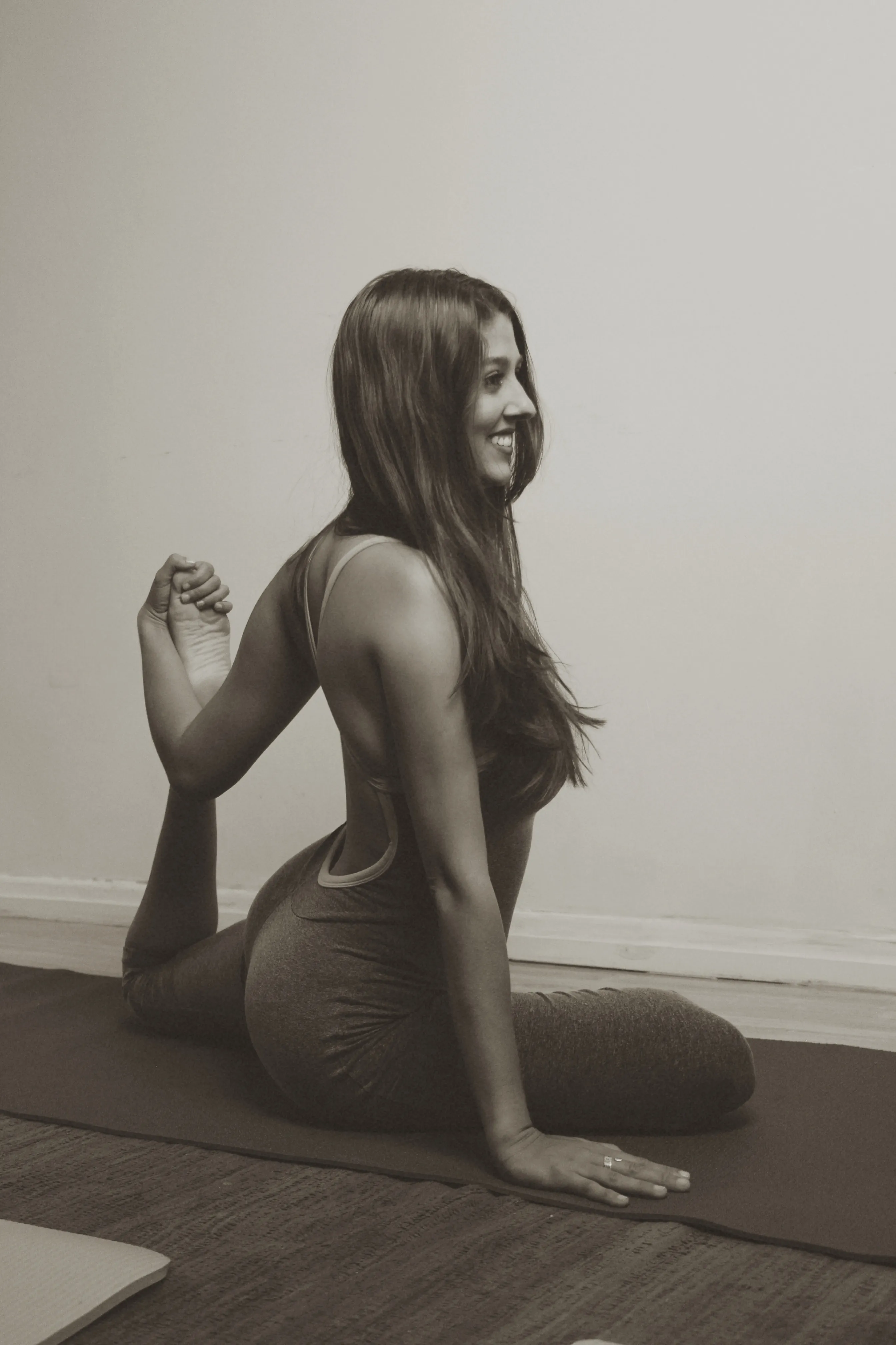 Agnes in a seated twist pose, black and white portrait